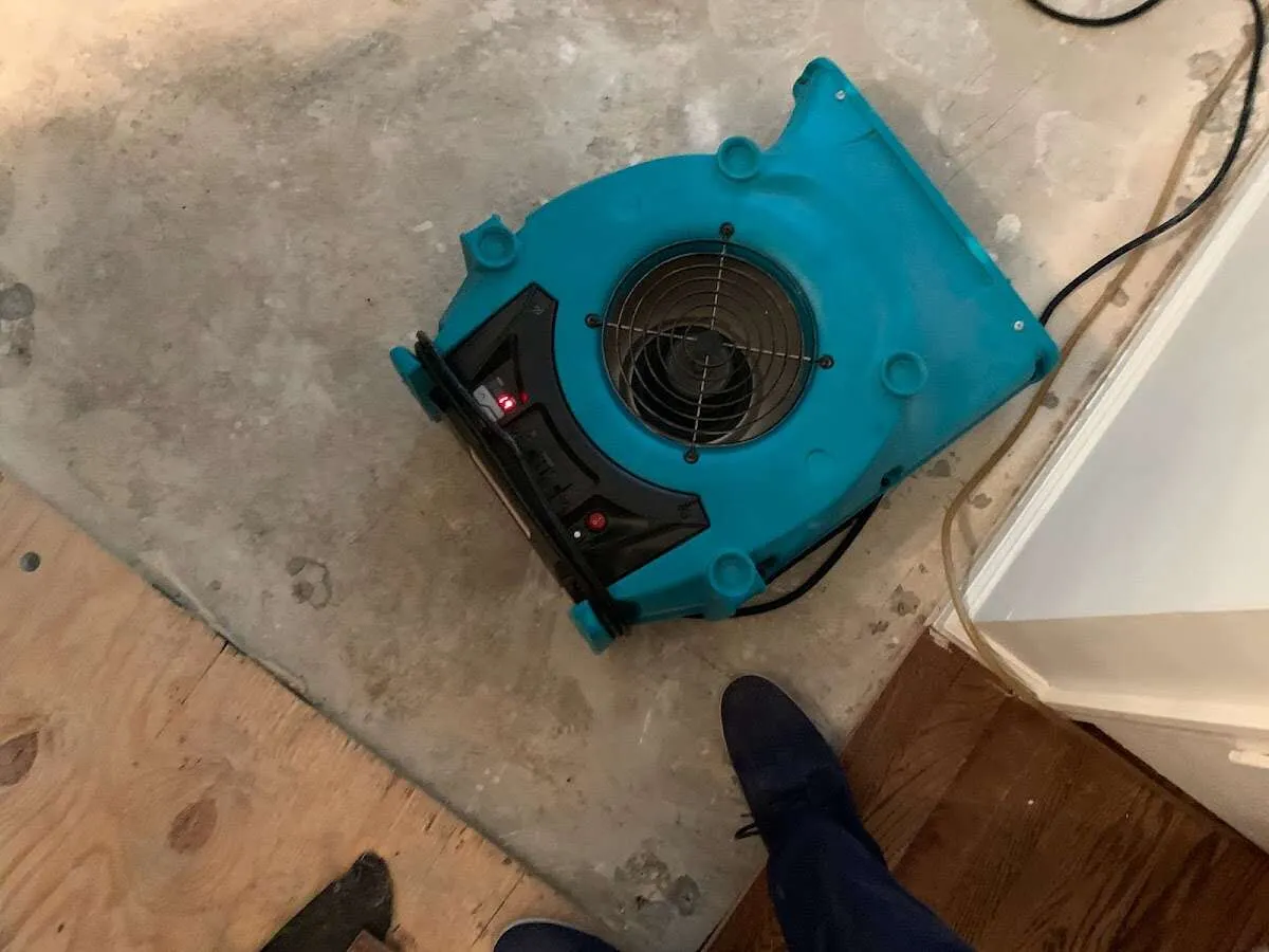Air mover drying subfloor during Commercial Water Damage Restoration in Topsfield